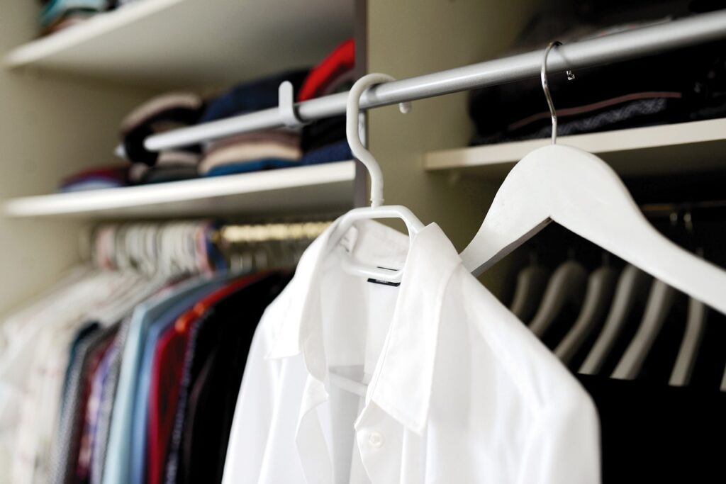 white dress shirt on hanger in closet